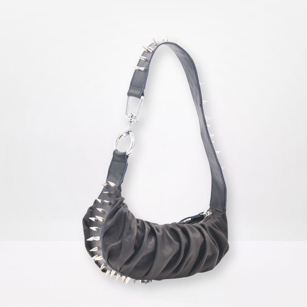 black  studded handbag on a white background