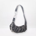 black  studded handbag on a white background