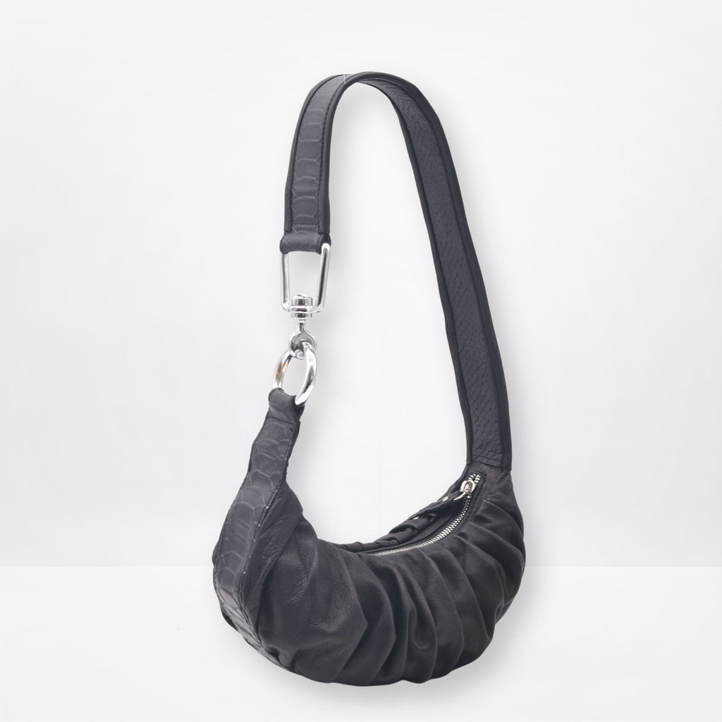 Black shoulder bag with a strap on a white background