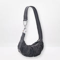 Black shoulder bag with a strap on a white background