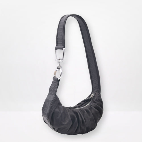 Black shoulder bag with a strap on a white background